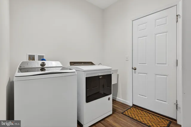 a view of deck with a large window and wooden floor