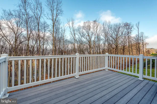 a aerial view of a house next to a big yard with large trees