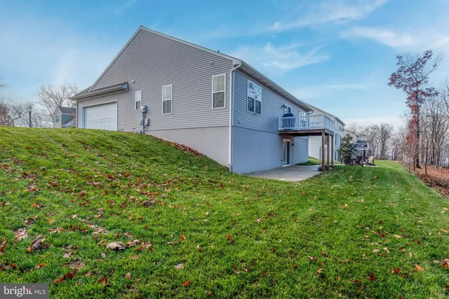 a aerial view of a house next to a big yard and large trees
