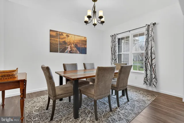 a view of a dining room with furniture wooden floor and a chandelier