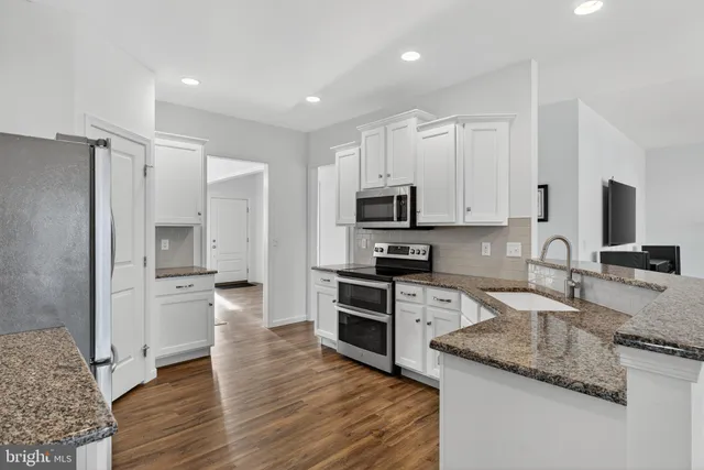 a kitchen with a refrigerator stove and sink