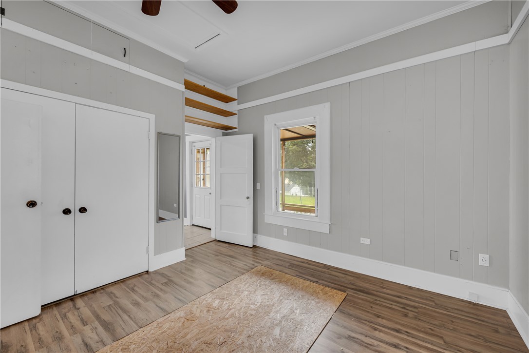 308 Verner Street Walhalla, SC 29691 - Photo 17 of 49 Wood flooring and vertical paneled walls define this versatile interior space with built-in shelving.