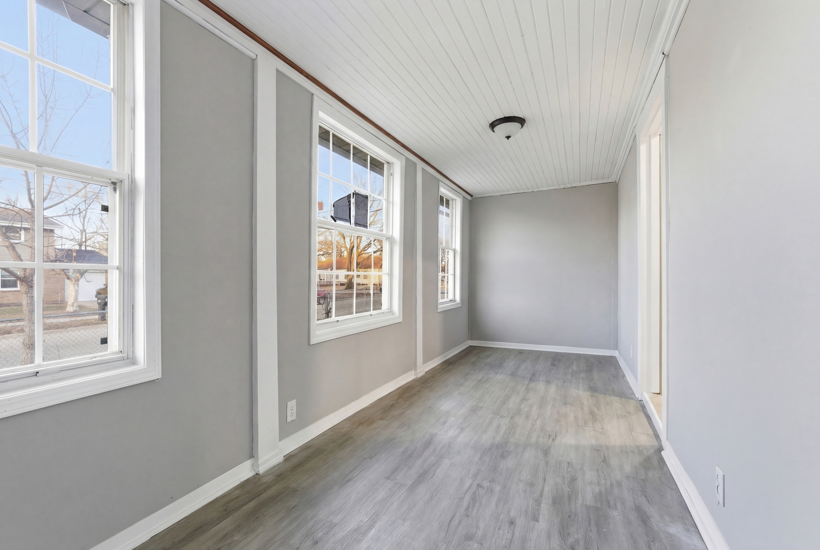 521 Fitch Road Rockford, IL 61109 - Photo 2 of 10 a view of an empty room with wooden floor and a window