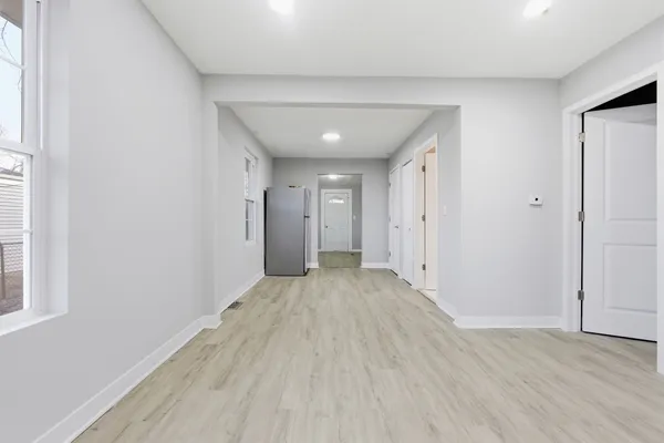 a view of a hallway with wooden floor