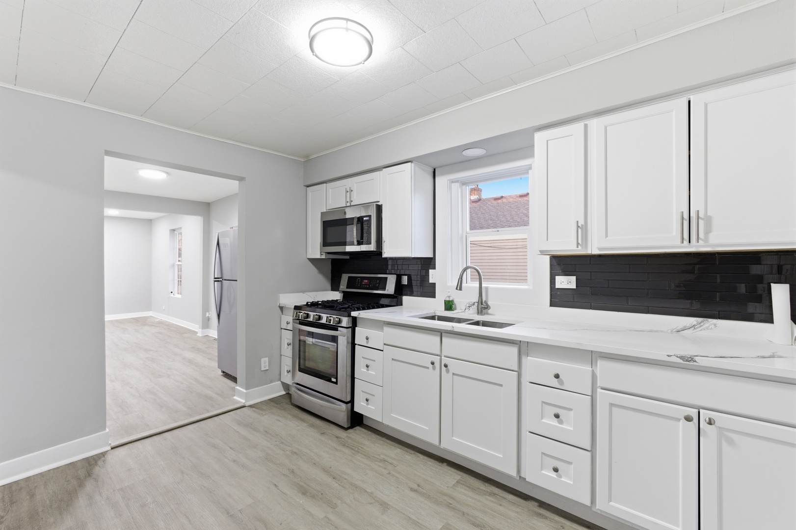 521 Fitch Road Rockford, IL 61109 - Photo 6 of 10 a kitchen with white cabinets sink and stainless steel appliances