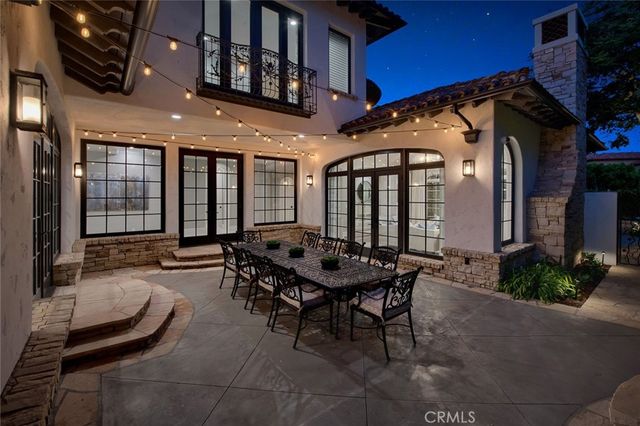 a bathroom with a sink a toilet a large mirror and shower