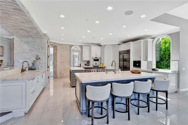 a living room with furniture large window and wall painting