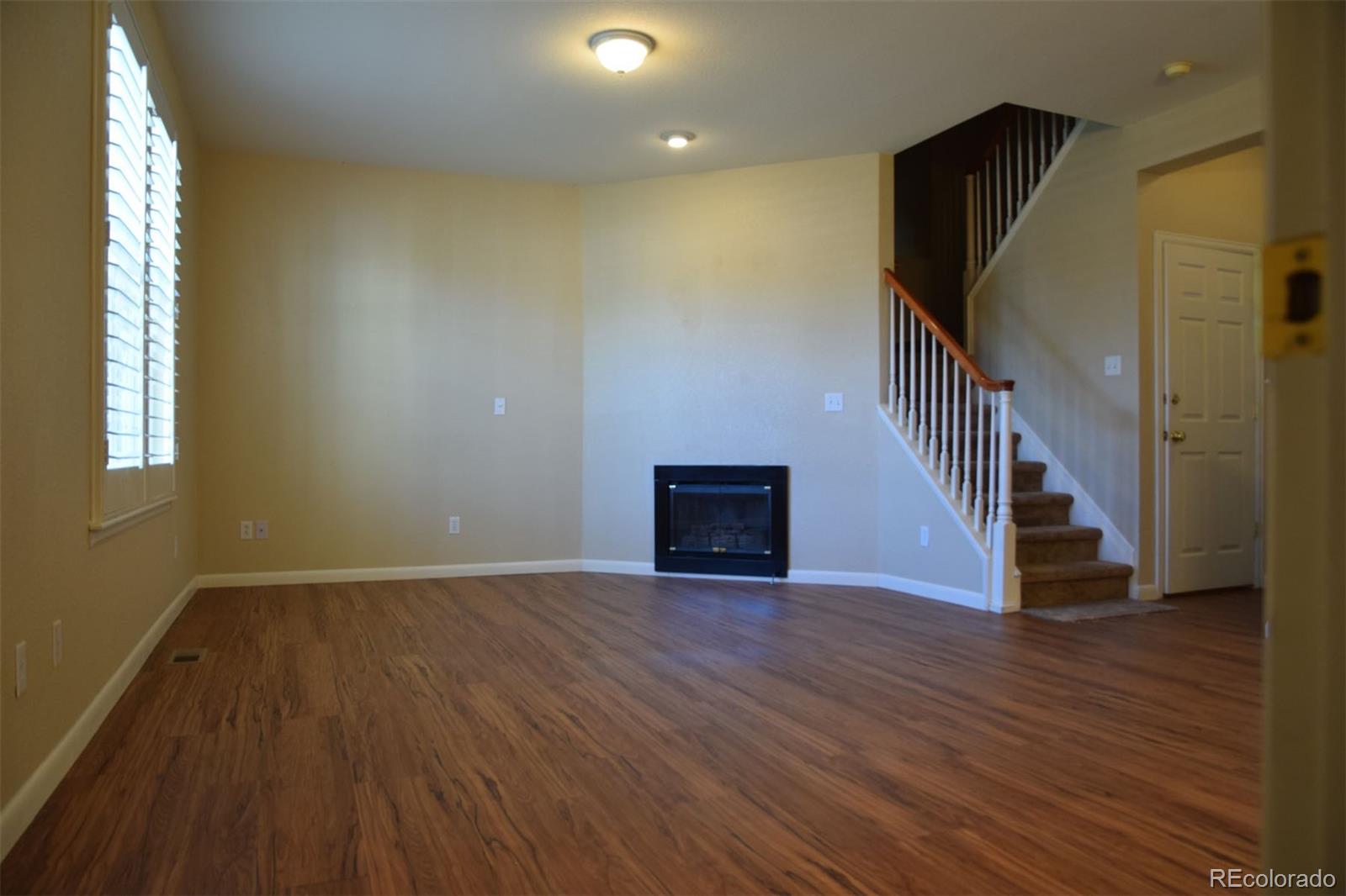 8237 West 54th Avenue, Unit 2 Arvada, CO 80002 - Photo 2 of 20 an entryway and a hallway with wooden floor