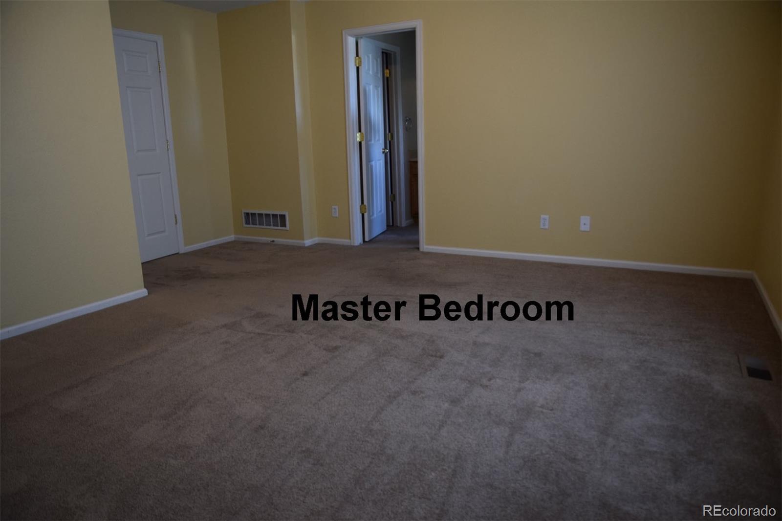 8237 West 54th Avenue, Unit 2 Arvada, CO 80002 - Photo 6 of 20 a view of a room with wooden floor and bench