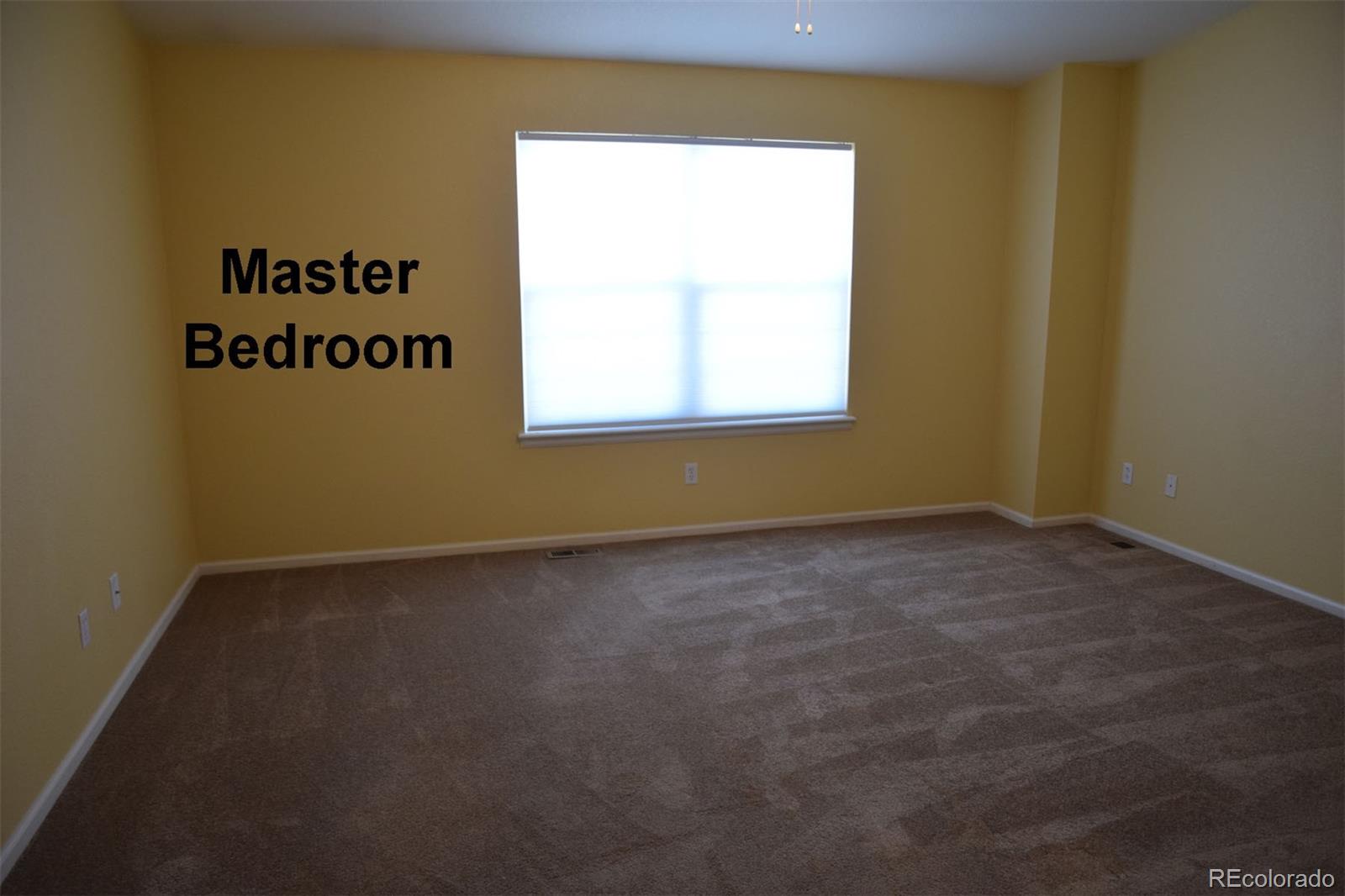 8237 West 54th Avenue, Unit 2 Arvada, CO 80002 - Photo 8 of 20 a view of an empty room with a window