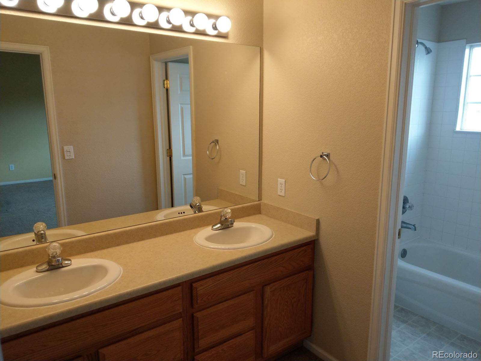 8237 West 54th Avenue, Unit 2 Arvada, CO 80002 - Photo 10 of 20 a bathroom with a sink and a mirror