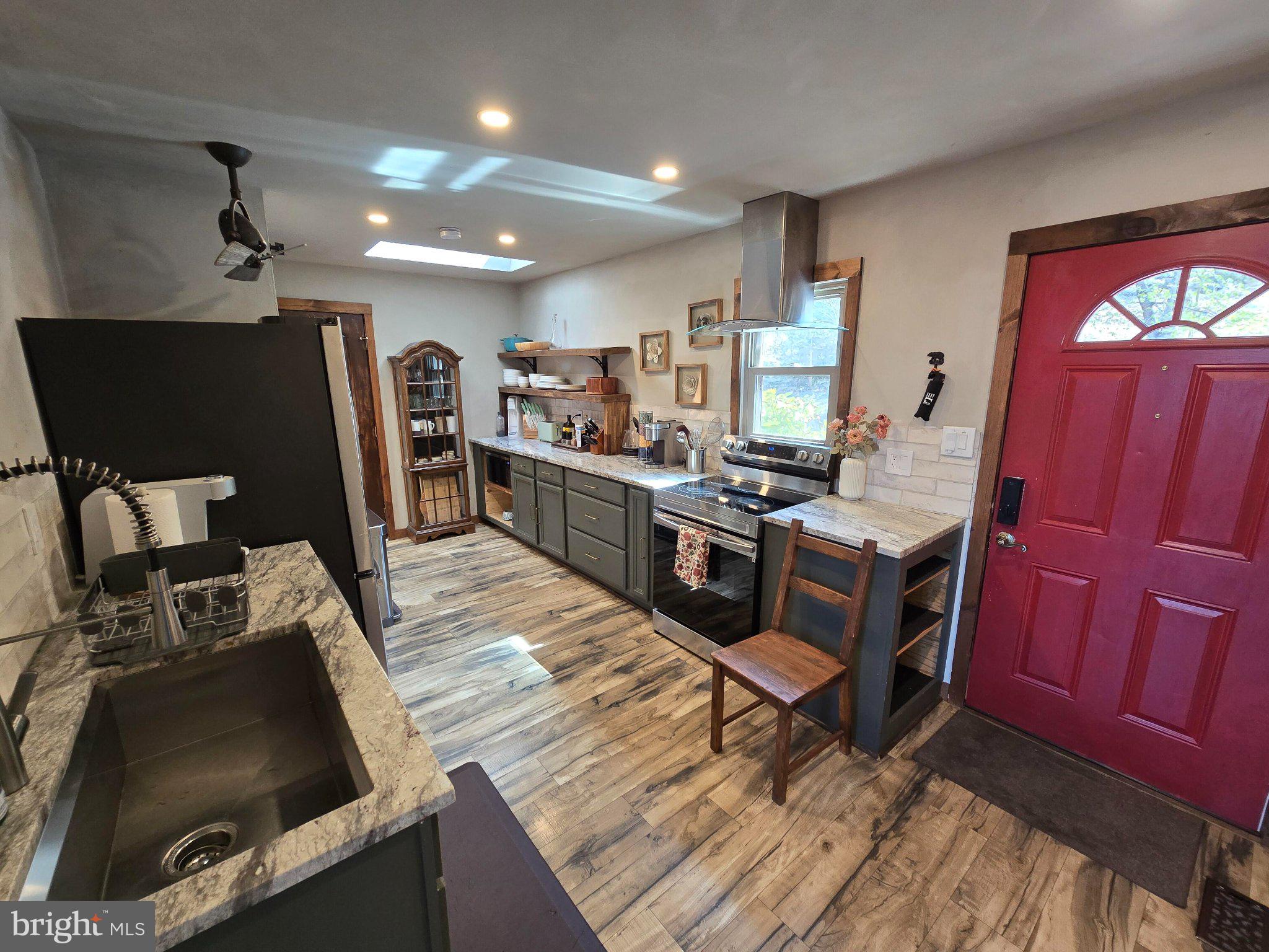 1614 High Top Road Linden, VA 22642 - Photo 10 of 25 Charming kitchen with vibrant red door.