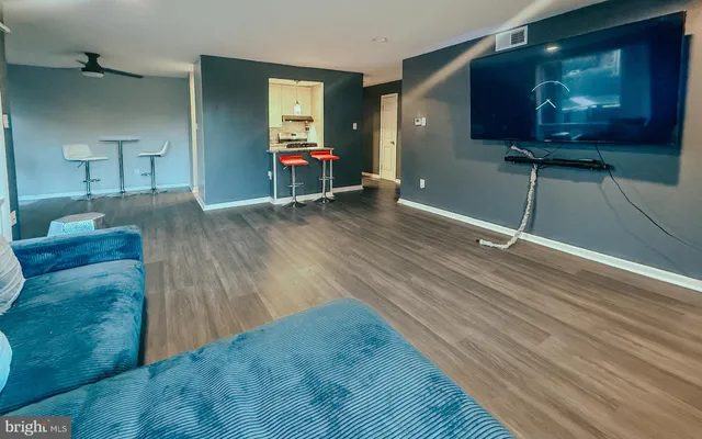 a view of a room with wooden floor and stairs