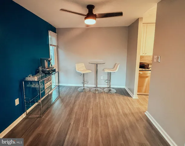 a view of empty room with wooden floor