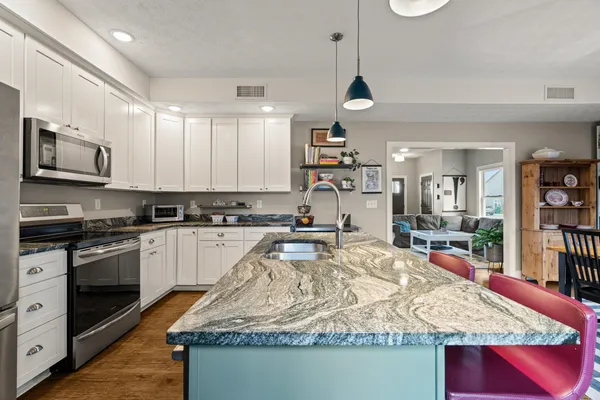 a view of a house with yard and a tree