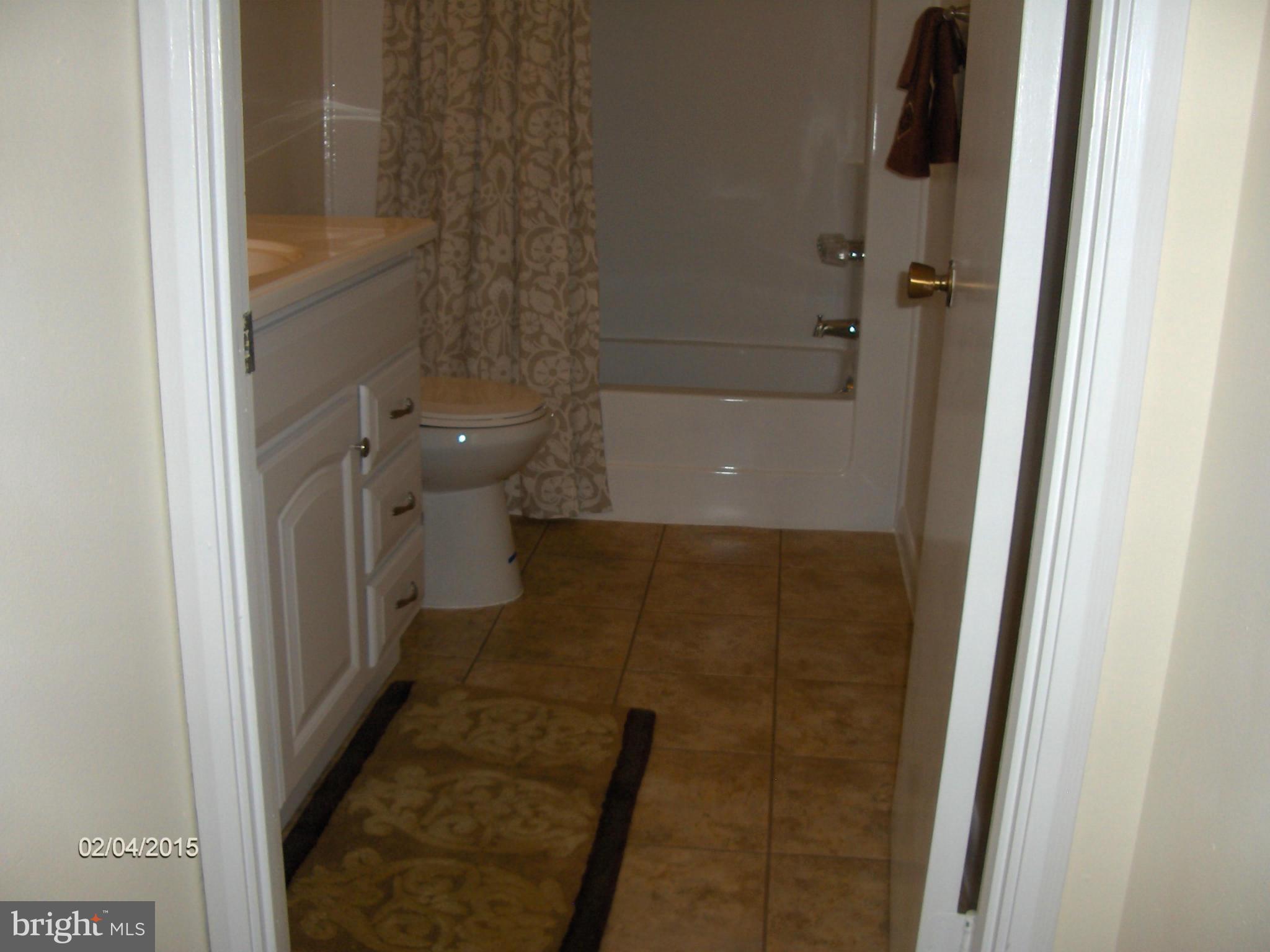 14502 Fiske Drive, Unit 138B Silver Spring, MD 20906 - Photo 19 of 21 a bathroom with a granite countertop shower and a toilet