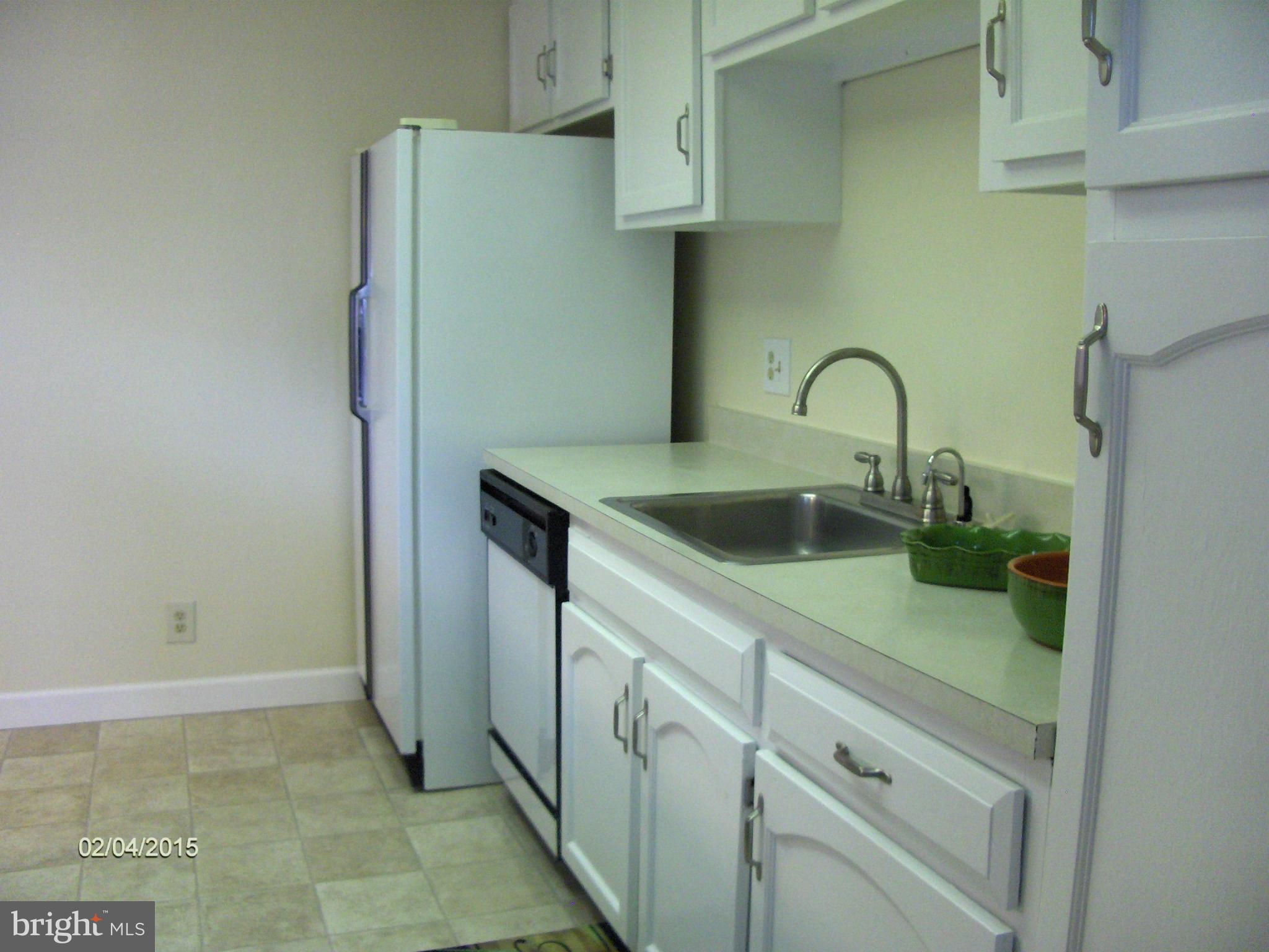 14502 Fiske Drive, Unit 138B Silver Spring, MD 20906 - Photo 9 of 21 a kitchen with a sink and a refrigerator