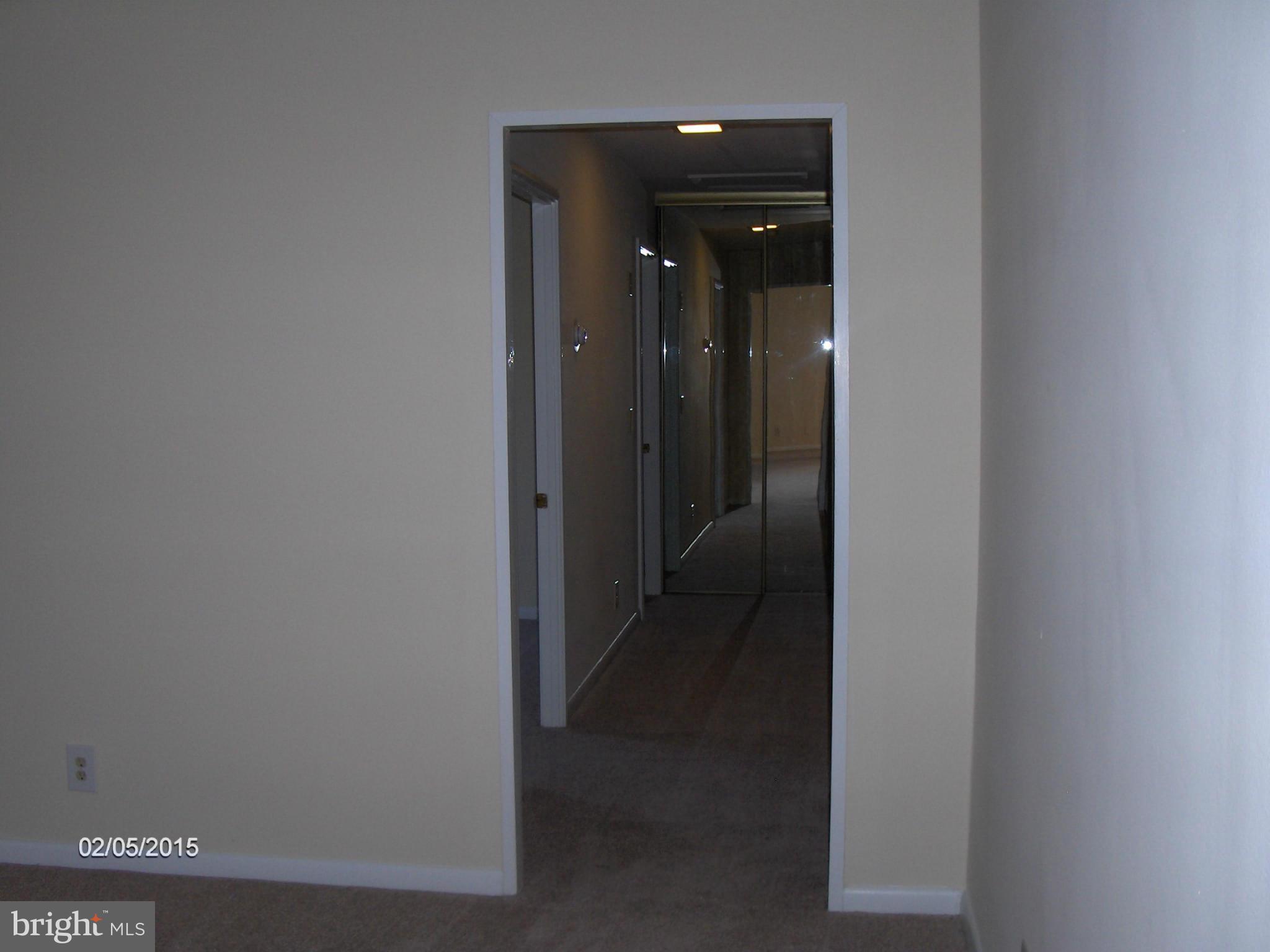 14502 Fiske Drive, Unit 138B Silver Spring, MD 20906 - Photo 10 of 21 a view of a hallway with a wooden door