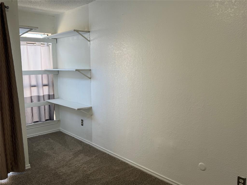 9803 Walnut Street, Unit 308 Dallas, TX 75243 - Photo 17 of 22 a view of cabinets and utility room with closet area