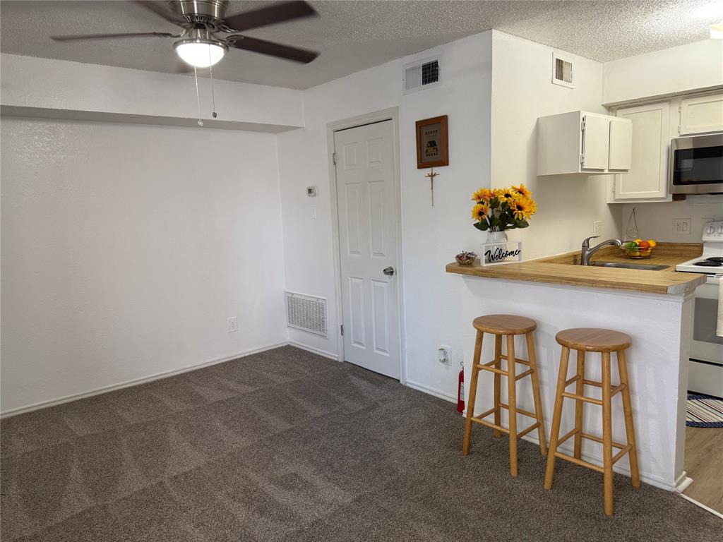 9803 Walnut Street, Unit 308 Dallas, TX 75243 - Photo 20 of 22 a kitchen with stainless steel appliances granite countertop a sink and cabinets