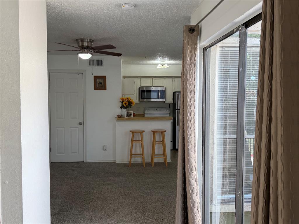 9803 Walnut Street, Unit 308 Dallas, TX 75243 - Photo 3 of 22 a view of a kitchen from the hallway