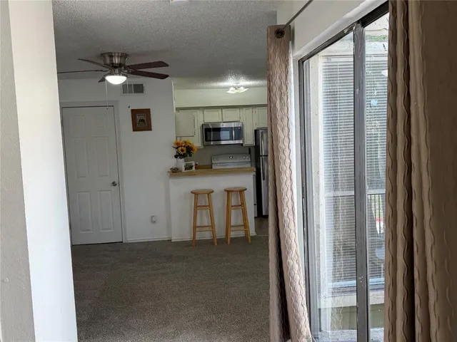 a view of a hallway with a kitchen