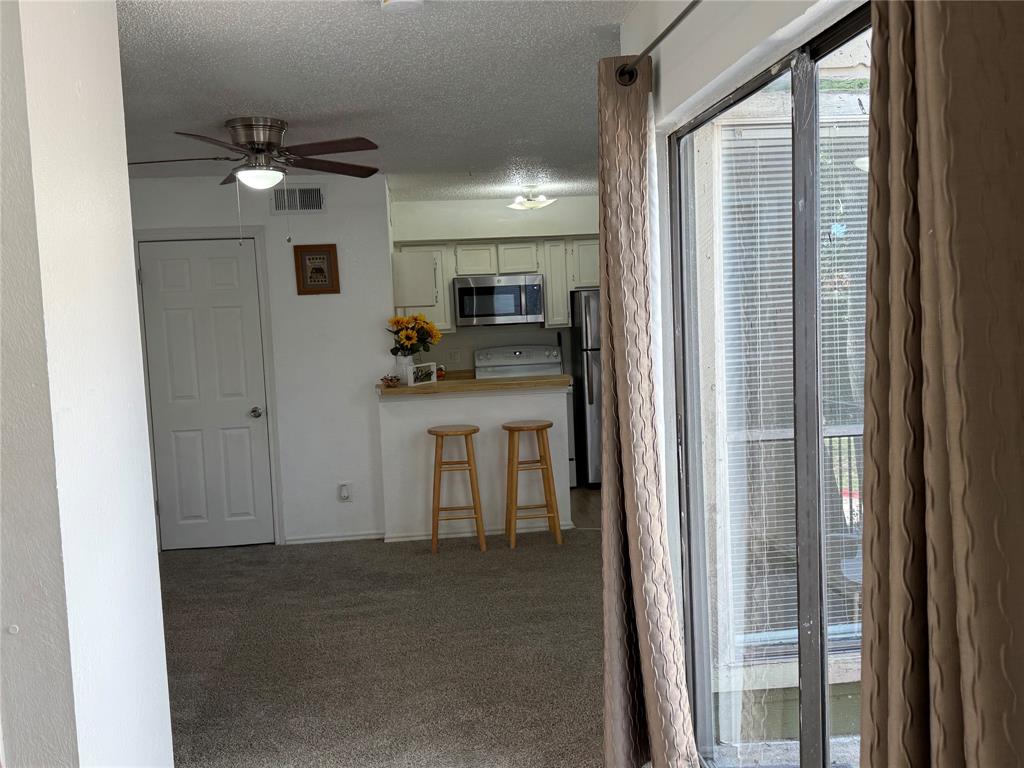 9803 Walnut Street, Unit 308 Dallas, TX 75243 - Photo 4 of 22 a view of a hallway with a kitchen