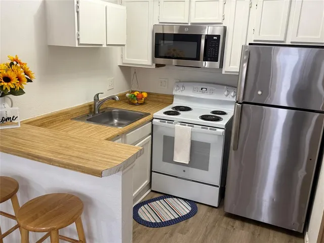 a kitchen with a stove a microwave and a refrigerator