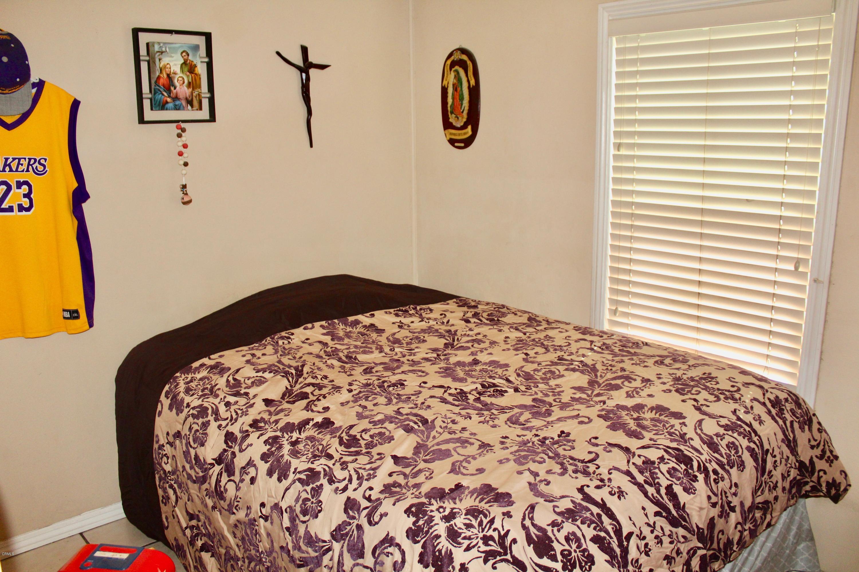 4145 Serena Lane, Unit 21 Oxnard, CA 93033 - Photo 12 of 16 a bedroom with a bed and a painting on the wall