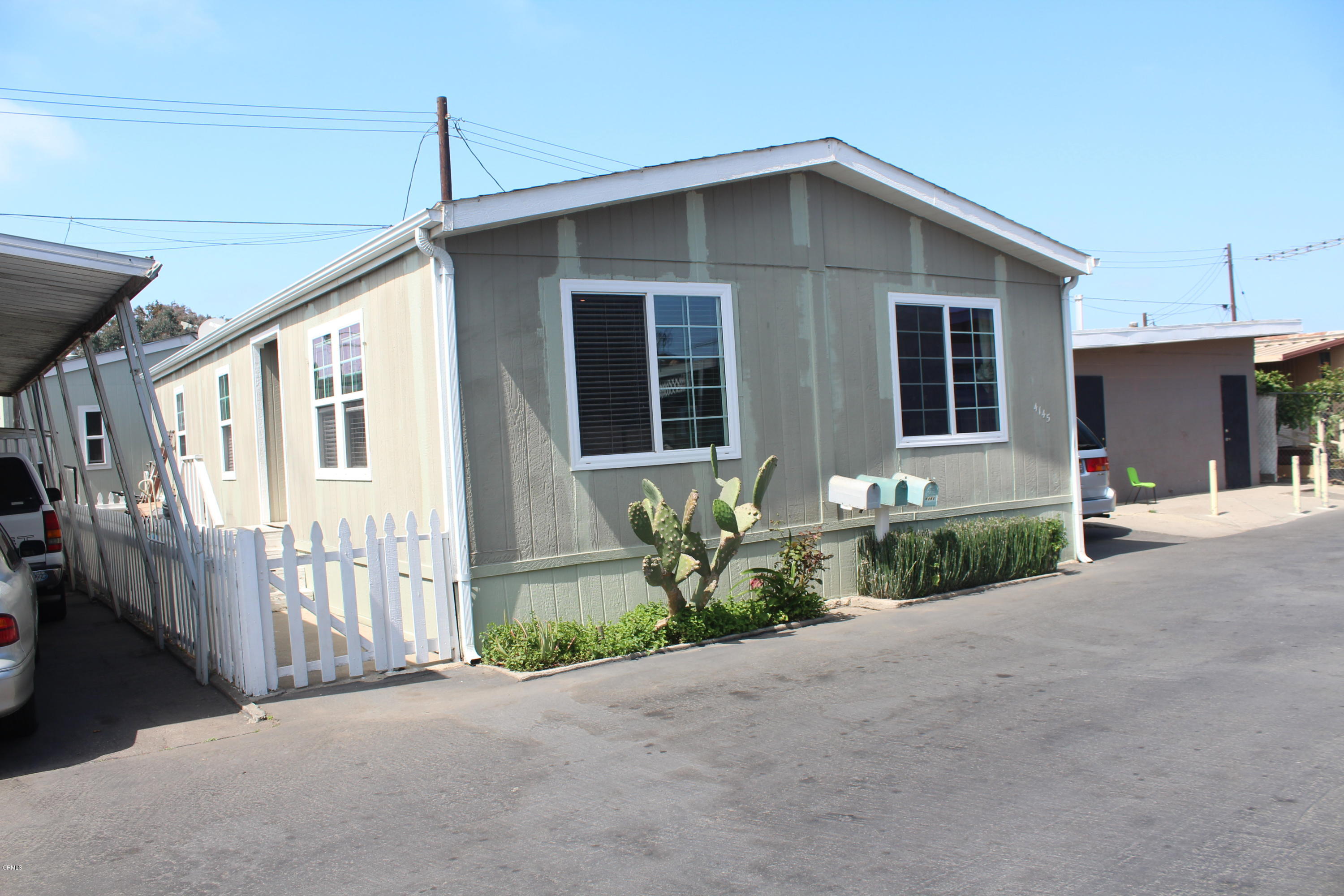 4145 Serena Lane, Unit 21 Oxnard, CA 93033 - Photo 16 of 16 a front view of a house with a yard and outdoor seating