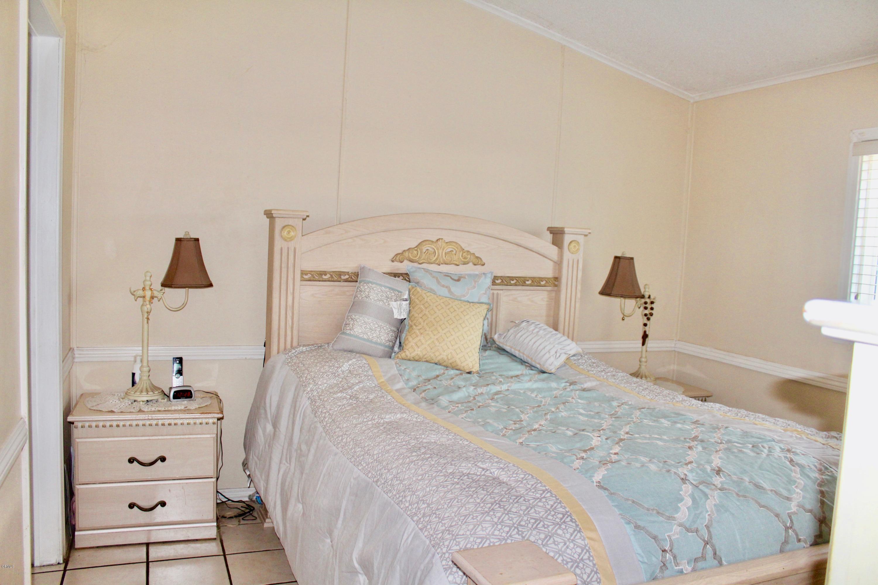 4145 Serena Lane, Unit 21 Oxnard, CA 93033 - Photo 7 of 16 a bedroom with a bed and a night stand