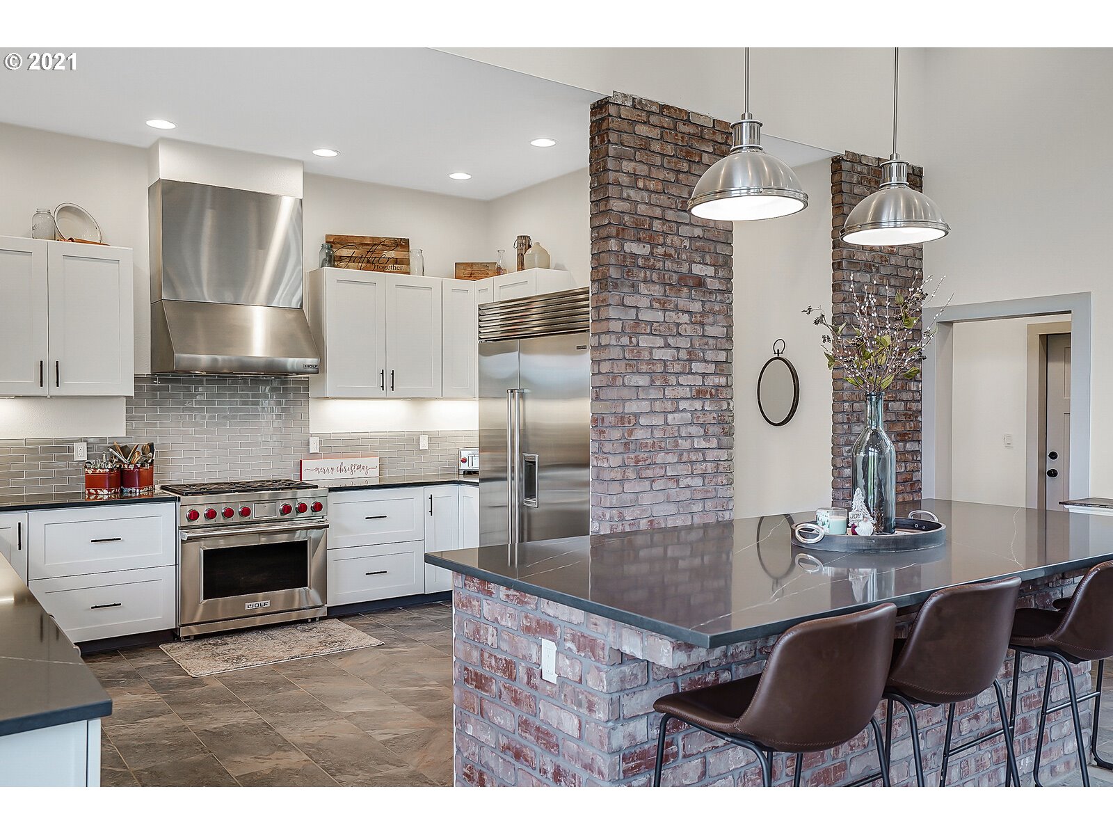 22280 Pittman Road Sheridan, OR 97378 - Photo 7 of 32 a kitchen with stainless steel appliances kitchen island granite countertop a table chairs and a refrigerator