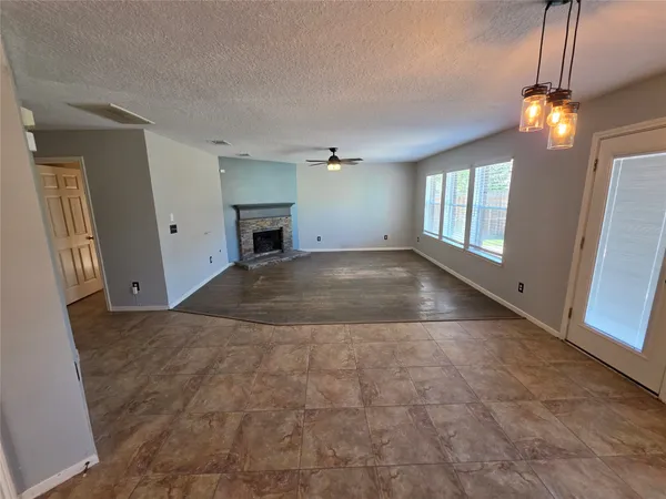 a view of a big room with windows and chandelier