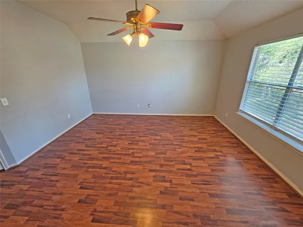 a view of bedroom with furniture and wooden floor