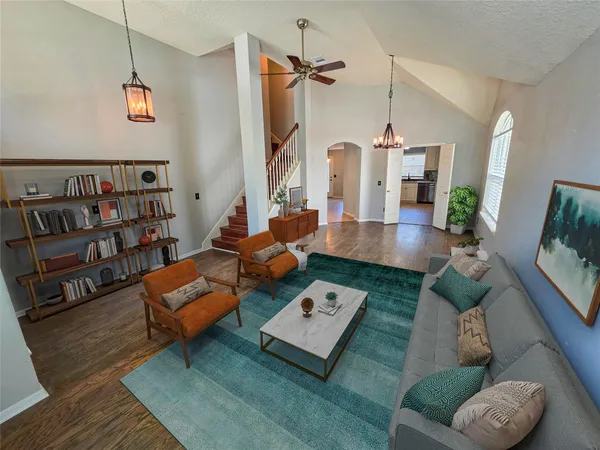 a living room with furniture and a book shelf