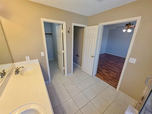 a bathroom with a sink a vanity a mirror and a bathtub
