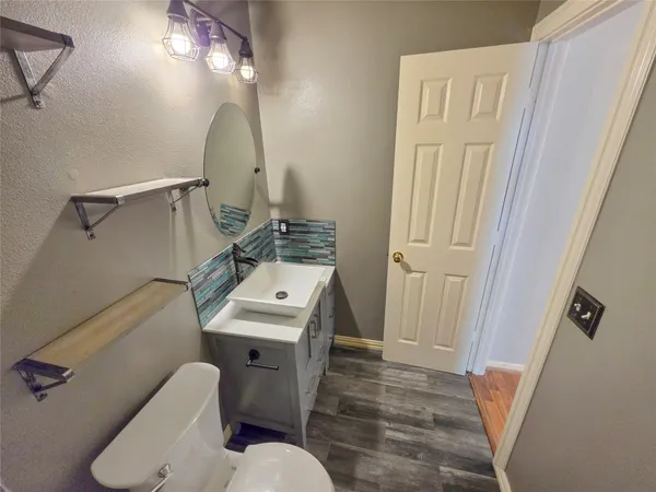 a bathroom with a sink and bathtub with toilet