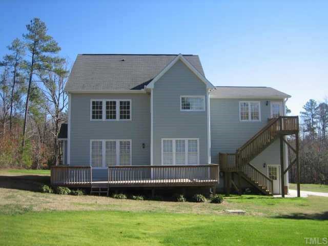 5479 Pearces Road Louisburg, NC 27549 - Photo 2 of 10 Back side, notice extra large lower level deck for entertaining, sep. entrance for upper bonus/4th bdrm