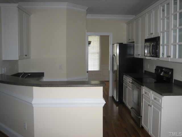 5479 Pearces Road Louisburg, NC 27549 - Photo 3 of 10 3/4' hrdwood floors, whitecabinets, new stainless steel appl. Corian counters and 1 piece sink. Fabulous!
