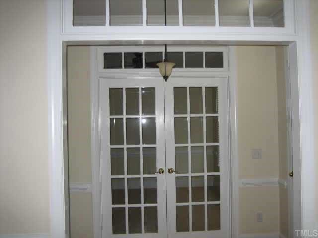5479 Pearces Road Louisburg, NC 27549 - Photo 6 of 10 No dining room is complete unless you have these pretty french doors, transom windows & wainstcoating!