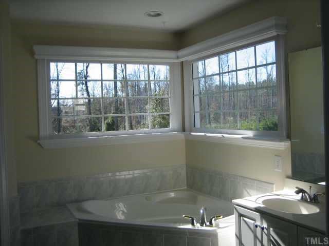 5479 Pearces Road Louisburg, NC 27549 - Photo 9 of 10 For the King & Queen, Jacuzzi garden tub, dual head shower, sep. watering closet,tile floors & dual vanity's
