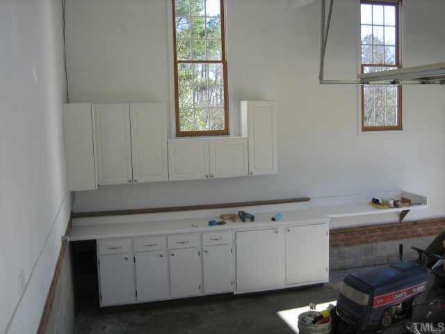 5479 Pearces Road Louisburg, NC 27549 - Photo 10 of 10 Oversized garage, painted sheetrocked and workshop with cabinets.