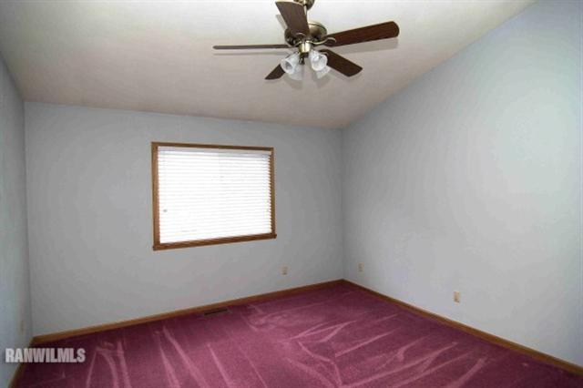 6680 North Point Road Rockford, IL 61108 - Photo 6 of 12 an empty room with a window and a ceiling fan