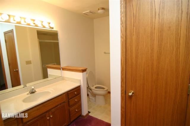6680 North Point Road Rockford, IL 61108 - Photo 8 of 12 a bathroom with a sink and a mirror