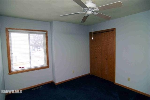 6680 North Point Road Rockford, IL 61108 - Photo 10 of 12 an empty room with a window and a ceiling fan