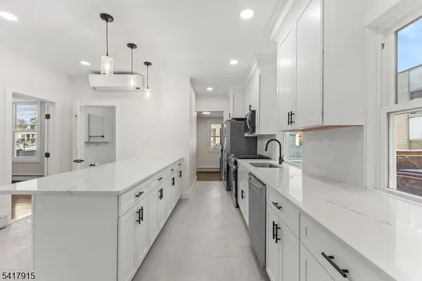 a utility room with sink dryer and washer