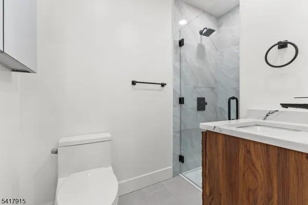 a large kitchen with stainless steel appliances granite countertop a sink a stove and a refrigerator