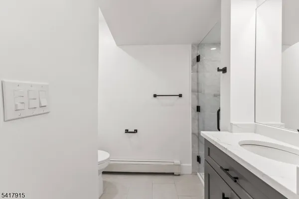 a kitchen with white cabinets and sink