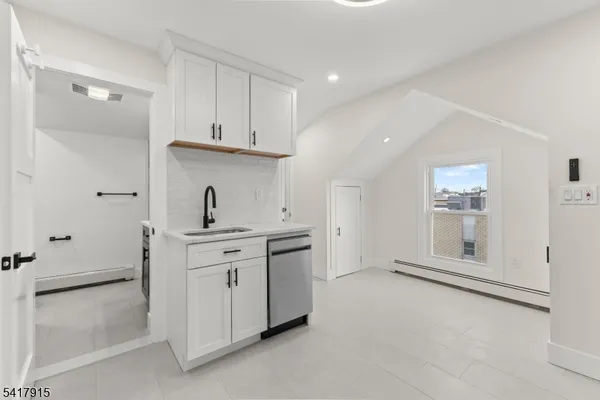 a kitchen with stainless steel appliances granite countertop a refrigerator and a stove