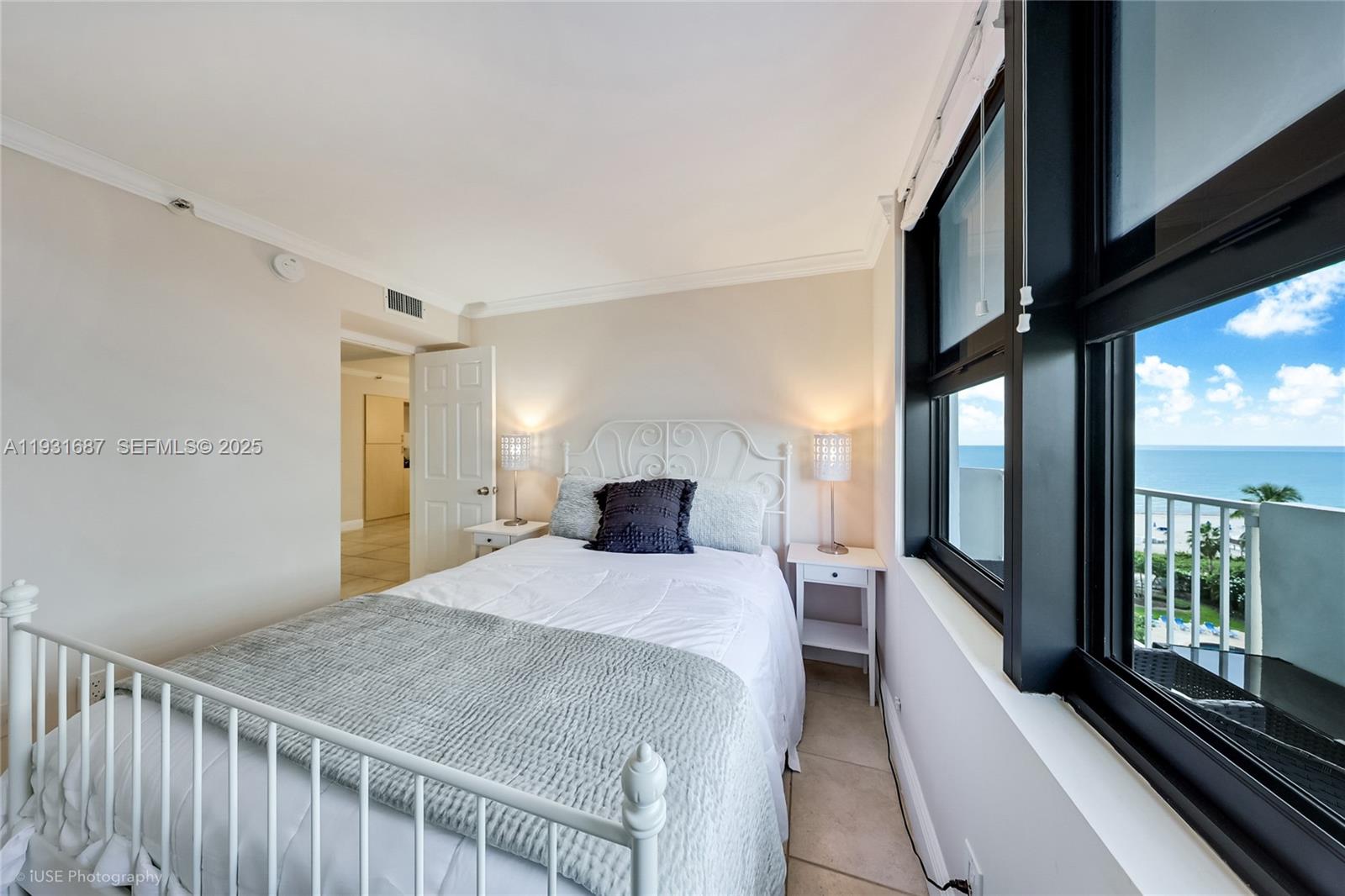 4301 Collins Avenue, Unit 803 Miami Beach, FL 33140 - Photo 19 of 25 a bedroom with a bed and a large window